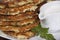 Vegetable fritters of zucchini with parsley and dill closeup .