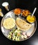 Vegetable Gujarati kathiyawadi thali on table, Indian thali meal