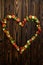 Vegetable heart on wooden background, top view