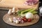 The vegetable ingredient on the circle wicker plate on black granite kitchen counter surface prepare for dinner cooking