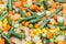 Vegetable mix salad closeup. Asparagus, carrot, corn, onion and green pea with seed oil.