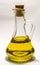 Vegetable oil in a transparent bottle decanter with stopper on a white background