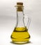 Vegetable oil in a transparent bottle decanter with stopper on a white background