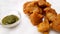 Vegetable pakora,Cauliflower pakora,served hot indian snack,served along with green chilly sauce