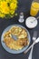 Vegetable pancakes on a plate, zucchini pancakes, sour cream, orange juice, dandelion bouquet, fork with knife, top view