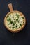 Vegetable pie quiche with broccoli and soft cheese over black