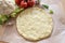 Vegetable pizza base from shredded cauliflower and cheese on baking paper, healthy alternative for low carb and ketogenic diet,