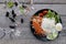 Vegetable salad on a black plate Laying on wooden slabs.