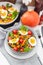 Vegetable salad with grilled carrot, cherry tomatoes, pumpkin, lettuce, boiled eggs and sesame seeds