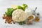 Vegetable salad ingredients: cauliflower, apples, lemon, almonds, parsley, yogurt, ginger, mustard, salt, black pepper and wine