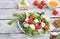 Vegetable salad with mozzarella cheese, cherry tomatoes, honey and fresh arugula, Healthy natural breakfast with lemon, detox diet