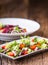 Vegetable salad. Plate of salad with vegetables on rustic oak table. Assortment of ingredients of vegetable salad