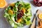 Vegetable salad with pomegranate seeds on a bright metal background