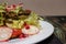 Vegetable salad with radish and lettuce lattuke on a white plate. Weight loss, proper nutrition, healthy food to