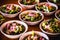 Vegetable salad, vegetables and flowers. multiple salad bowls with arugula, flower petals, vegan toast