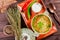 Vegetable soup, broth with noodles, herbs, parsley and vegetables in bowl with sour cream, spice, pepper, dried thyme and bread