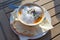 Vegetable soup with fresh sprouts and foam garnish as appetizer at a garden party menu on a wooden table, selected focus