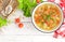 Vegetable soup. Healthy food, vegetarian dish. Vegetable soup with cabbage, potato, tomato, carrot, celery, pepper and green peas.