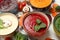 Vegetable soups and ingredients on white background, close up