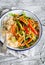 Vegetable stir-fry and rice in an enamel plate