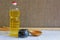 Vegetable sunflower oil in transparent bottle, wooden spoon and