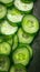 Vegetable textures Backlit slices of fresh green cucumbers, close up