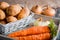 Vegetables in a basket: beets, onions, garlic, dill, potatoes, carrots on an old wooden background