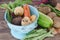 Vegetables with blue drainer on wooden background.