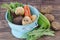 Vegetables with blue drainer on wooden background.