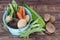 Vegetables with blue drainer on wooden background.