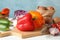 Vegetables, board and knife on white wooden background