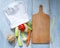 Vegetables in chef\'s hat and empty cutting board