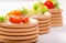 Vegetables on crackers: tomatoes, cheese and greens