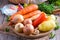 Vegetables on a cutting board. Onions, carrots, parsnips, peppers, garlic