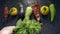 Vegetables, eggplant and pepper in drops of water. Man lays fresh green grass