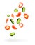 vegetables are flying, pepper, cucumber tomato slices are falling isolated on white