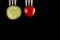 Vegetables on fork, four veggies, cucumber, tomato, broccoli, mushroom, on black background, close up