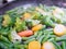 Vegetables fried in a pan close-up. Steam is coming. Defocus. vegetarian barely. Eco food