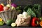 Vegetables, fruits, wicker basket and paper bag on wood background