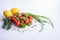 Vegetables, green onions, lemons, basil and fresh tomatoes on the table