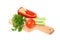 Vegetables (pepper, tomato, parsley) lie on cutting board