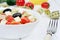 Vegetables salad with cheese in a bowl and centimeter on table