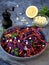 Vegetables salad with purple cabbage, carrot, sprouted mung, parsley on grey clay plate on dark background. Cole Slaw Salad of red