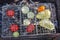 Vegetables slices between grill grates during grilling on brazier, outdoors