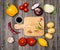 Vegetables and spices and empty old cutting board. Colorful ingredients for cooking on rustic wooden table around empty cutting b