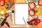 Vegetables, spices and notepad for recipes, on wooden table