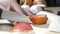 Vegetables tomatoes being cut into pieces