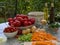 Vegetables, tomatoes, onions, chopped celery, carrot and basil leaves on the table with bottles of olive oil and balsamico vinegar