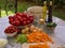 Vegetables, tomatoes, onions, chopped celery, carrot and basil leaves on the table with bottles of olive oil and balsamico vinegar