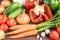 Vegetables on wooden background. Carrot, red pepper, cucumbers, tomatoes, garlic, potatoes and onions